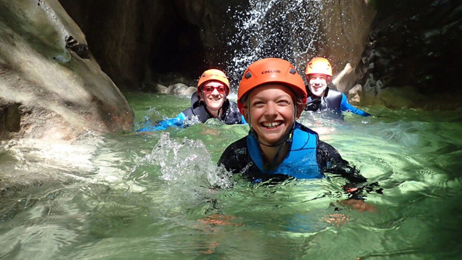 family canyoning in the water