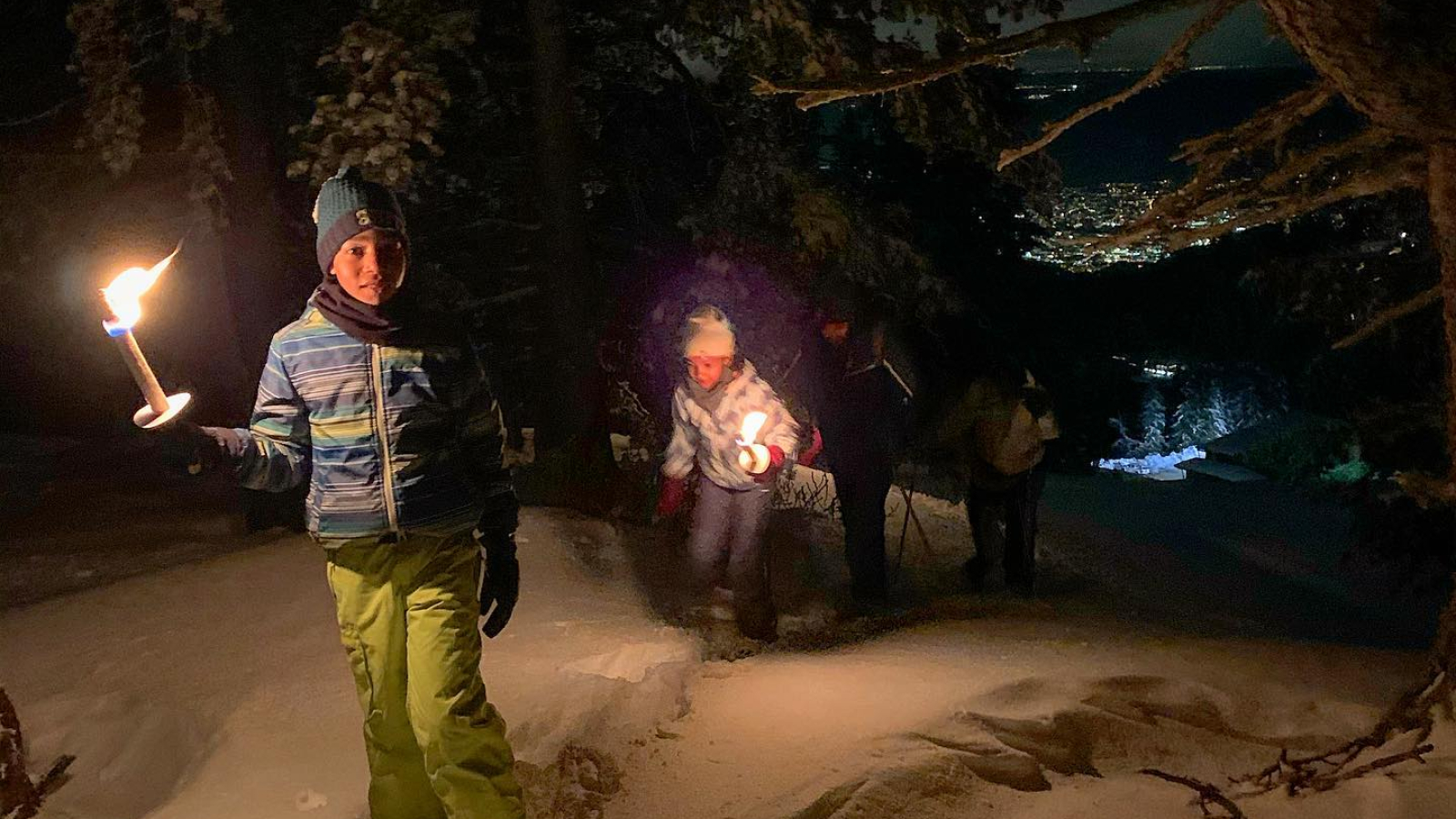 night snowshoeing with torches