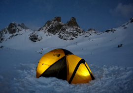 Unusual night in a tent on a frozen lake Chamrousse