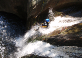 Sliding on a canyoning waterfall