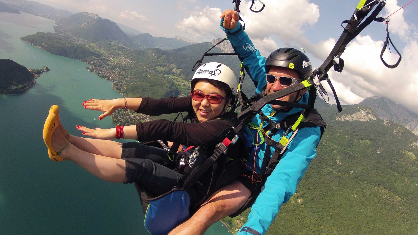 Tandem paragliding flight above lake Annecy